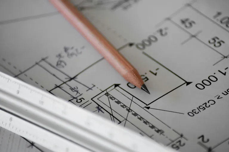 Blueprint and construction drawings on a planning desk